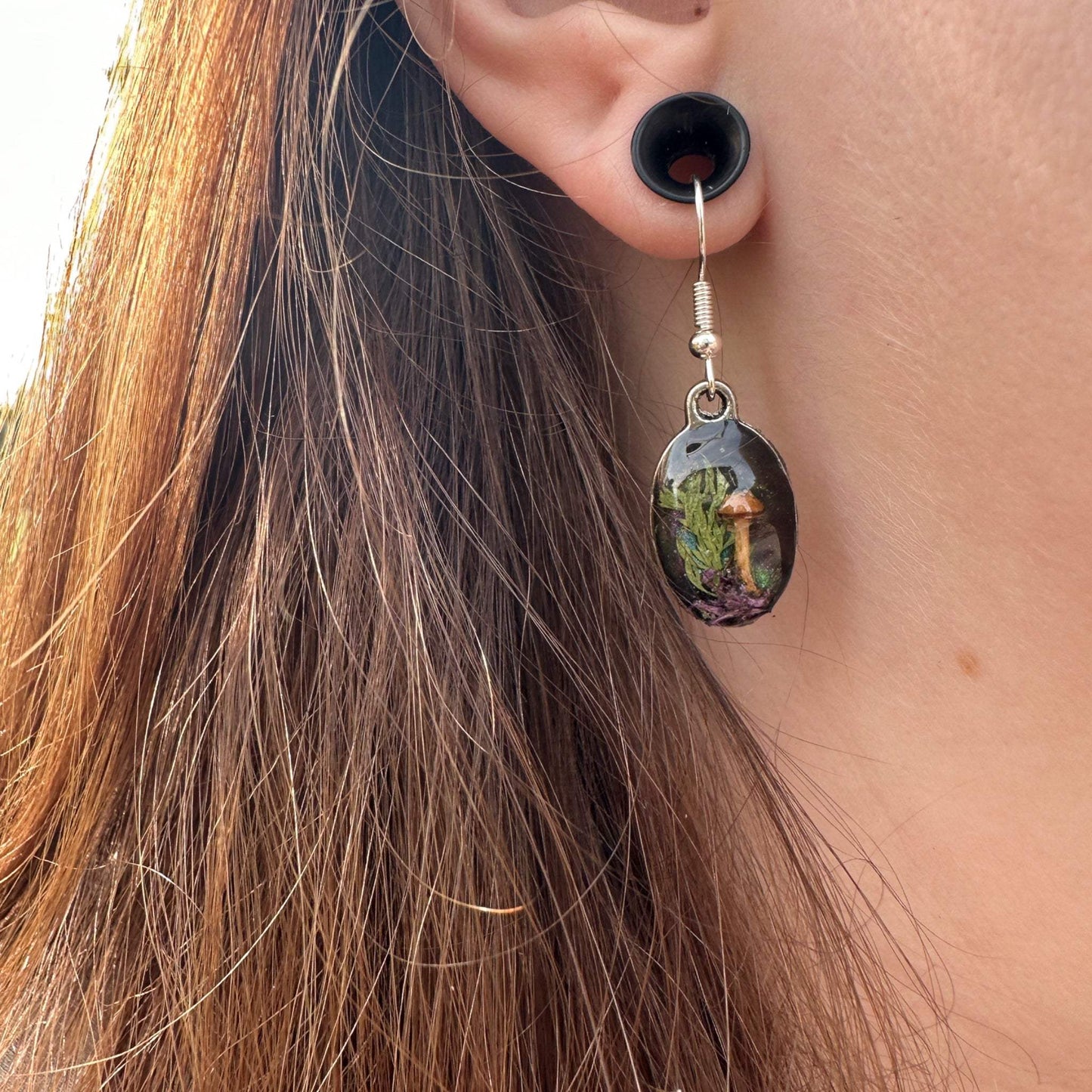 A mini botanical Garen with real mushrooms, moss and dried botanicals set with a colour shifting background. Silver drop Earring set for nature lovers and great gift idea