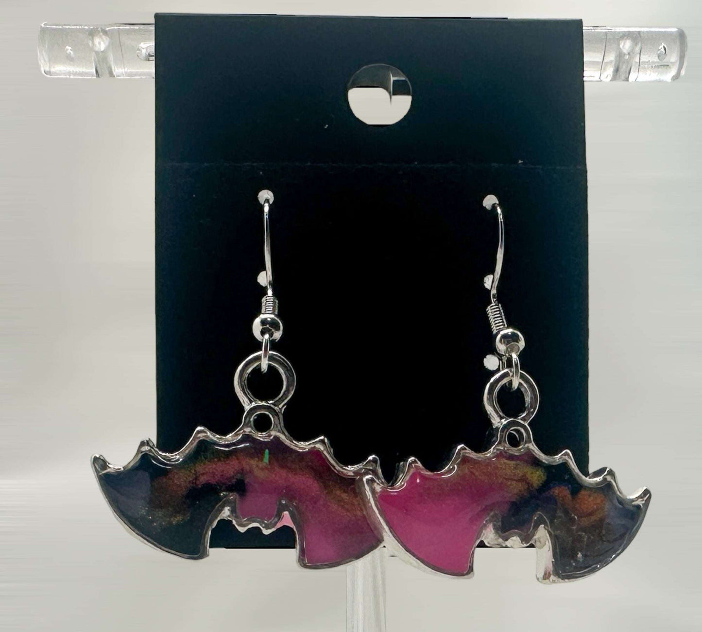 Hanging upside down bat earrings in pink and black